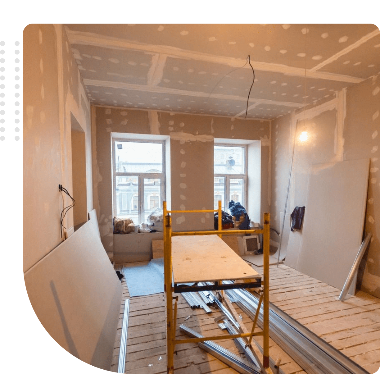 Room under renovation with drywall installation in progress.