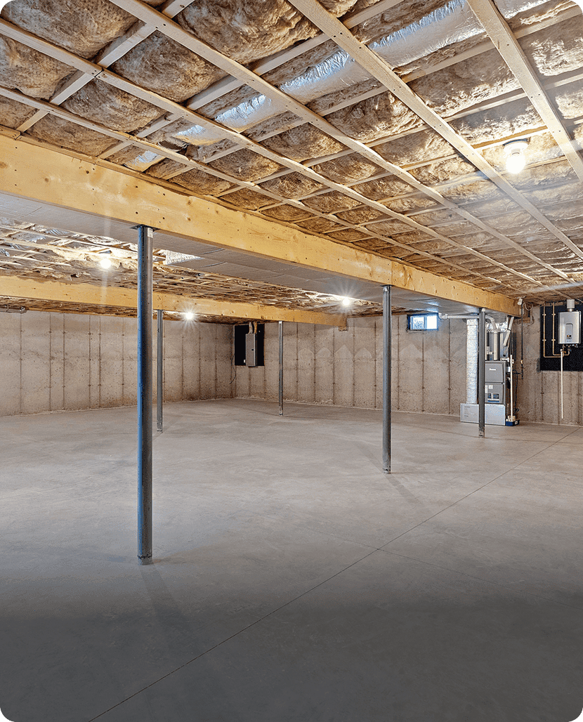 Unfinished basement with exposed ceiling and poles.