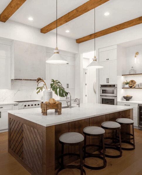 Modern kitchen with a large island and white cabinetry.